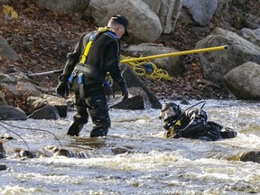 Sûreté du Quèbec divers search for a missing child near the shore of the Rivière des Mille Îles in Laval on Saturday, Oct. 29, 2022.