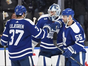 Toronto Maple Leafs goalie Matt Murray (centre) celebrates a win over the Buffalo Sabres with defencemen Timothy Liljegren (left) and Mark Giordano at Scotiabank Arena.