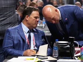 Montreal Canadiens executive vice-president of hockey operations Jeff Gorton, left, and general manager Kent Hughes confer during NHL draft at the Bell Centre in Montreal on July 7, 2022.