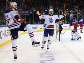 Leon Draisaitl #29, left, of the Edmonton Oilers is joined by Zach Hyman as he celebrates scoring the game-winning goal on the powerplay at 17:58 of the third period against the New York Rangers at Madison Square Garden on Saturday, Nov. 26, 2022, in New York City. The Oilers defeated the Rangers 4-3.