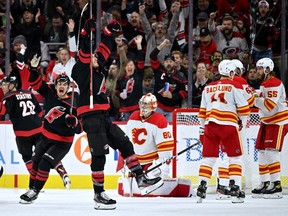 RALEIGH, NORTH CAROLINA - NOVEMBER 26: Brett Pesce #22 of the Carolina Hurricanes celebrates aftetr scoring the game-winning goal against the Calgary Flames during the first period of their game at PNC Arena on November 26, 2022 in Raleigh, North Carolina.