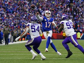 Buffalo Bills quarterback Josh Allen throws the ball against Minnesota Vikings linebacker Eric Kendricks (54) and defensive lineman Khyiris Tonga.