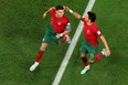 Cristiano Ronaldo (left) of Portugal celebrates with Joao Felix after scoring their team's first goal via a penalty against Ghana.