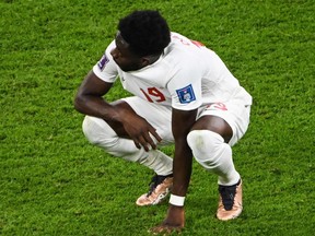 Canada's Alphonso Davies reacts after the World Cup Group F football match against Belgium.