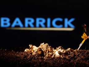 A small toy figure and imitation gold are seen in front of the Barrick logo in this illustration taken Nov. 19, 2021.