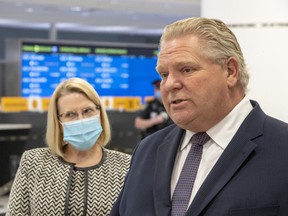 Ontario Premier Doug Ford and Solicitor General Sylvia Jones answer questions after touring the COVID-19 testing centre in Terminal 3 at Pearson Airport in Toronto on February 3, 2021.