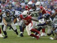 Nov 6, 2022; Arizona Cardinals running back Eno Benjamin (26) breaks through against the Seattle Seahawks during the second half in Glendale, Arizona, USA; at State Farm Stadium.