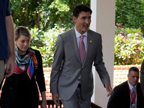 Prime Minister Justin Trudeau walks Melanie Joly, Minister of Foreign Affairs, after an emergency meeting during the G20 Summit at Nusa Dua in Bali, Indonesia, Wednesday, Nov. 16, 2022.