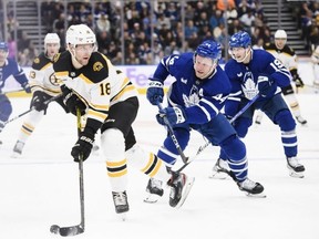 Boston Bruins forward Pavel Zacha looks for a pass under pressure from Leafs defenceman Morgan Rielly at Scotiabank Arena last night. Christopher Katsarov/THE CANADIAN PRESS