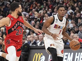 Miami Heat guard Kyle Lowry (7) tries to dribble around Toronto Raptors guard Fred VanVleet (23) during the first half at Scotiabank Arena.