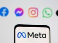 Facebook's parent company logo Meta is seen on a smartpone in front of displayed logos of Facebook, Messenger, Instagram and Whatsapp in this illustration photo taken Oct. 28, 2021.