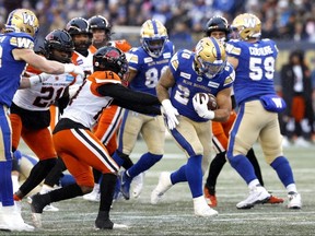 Winnipeg Blue Bombers running back Brady Oliveira (20) breaks a tackle from BC Lions defensive back Marcus Sayles (14) in the first half at Investors Group Field. James Carey Lauder-USA TODAY Sports