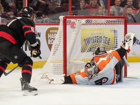 Philadelphia Flyers goalie Carter Hart (79) makes a save in front of Ottawa Senators center Derick Brassard (61) in the first period at the Canadian Tire Centre on Saturday night.