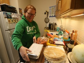 Christina prepares food she received from a local food bank. Persistent inflation has meant more people are turning to food banks for help.