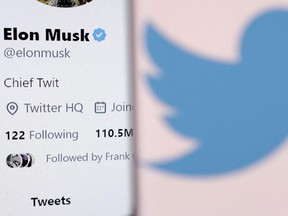 Elon Musk's account and the Twitter logo are seen in this illustration Oct. 28, 2022.
