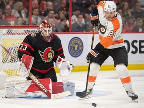 Flyers centre Scott Laughton tries to deflect a shot on in front of Ottawa Senators goalie Cam Talbot at the Canadian Tire Centre. Talbot was solid in his first start of the season Saturday, stopping 26 of 28 shots in the 2-1 loss to Philadelphia.