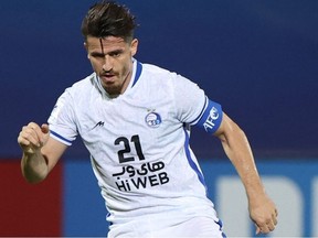 In this file photo Esteghlal's defender Voria Ghafouri plays during the AFC Champions League group C match between Saudi's Al-Ahli and Iran's Esteghlal on April 27, 2021, at the King Abdullah sport city stadium in the Saudi city of Jeddah.