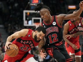 Chicago Bulls guard Ayo Dosunmu (12) works to block Toronto Raptors guard Fred VanVleet (23) during second half NBA basketball action in Toronto, Sunday, Nov. 6, 2022.
