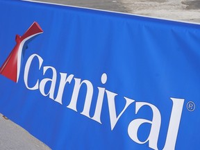 This Jan. 29, 2021 file photo shows a Carnival Cruise Line sign at Port Miami in Miami.