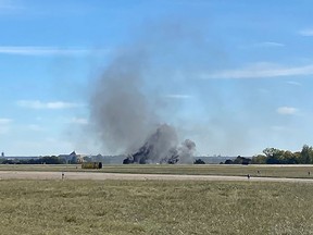 This image obtaimned from the twitter account @GollyItsMollie, shows smoke rising from the crash after two planes collided mid-air during the Wings Over Dallas Airshow at Dallas Executive Airport, in Dallas, Texas, on November 12, 2022.