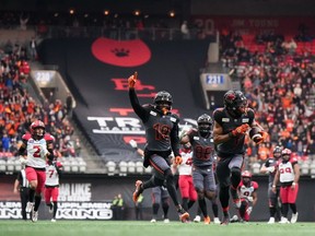 B.C. Lions' Keon Hatcher (4) runs the ball into the end zone for a touchdown after making a reception as Dominique Rhymes (19) and Jevon Cottoy (86) celebrate during the second half of the CFL western semi-final football game against the Calgary Stampeders at B.C. Place on Sunday.