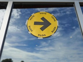 A sign points the way to a polling station for voting in the 2021 federal election in Oshawa, Ont. Sept. 20, 2021.