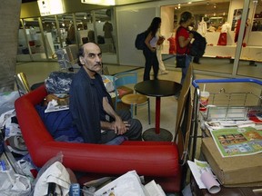 Merhan Karimi Nasseri sits among his belongings at Terminal 1 of Roissy Charles De Gaulle Airport, north of Paris, Aug. 11, 2004.