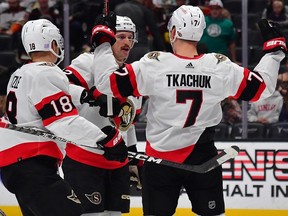 Senators teammates Tim Stutzle (18) and Thomas Chabot celebrate with Brady Tkachuk after he scored a power-play goal against the Ducks in the first period of Friday's game.