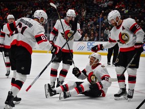 Senators teammates Derick Brassard (61), Shane Pinto (57) and Claude Giroux (28) celebrate the goal by Mathieu Joseph (21) during the third period of Friday's game against the Ducks.