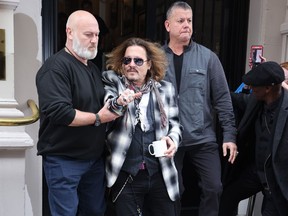 Actor and musician Johnny Depp is seen leaving the Birmingham Grand Hotel in Birmingham, England, in June 2022.