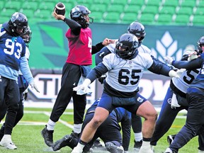 Dariusz Bladek, part of a greatly improved offensive line, provides the protection as Argonauts quarterback McLeod Bethel-Thompson throws the ball during yesterday’s Grey Cup practice at Mosaic Stadium in Regina.
