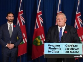 Ontario Premier Doug speaks during a press conference, as Education Minister Stephen Lecce looks on, at Queen's Park in Toronto on Monday Nov. 7, 2022. Ontario is set to repeal legislation today that imposed a contract on education workers and banned their right to strike.