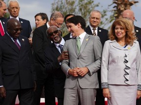 Prime Minister Justin Trudeau laughs with fellow leaders as they take part in the family photo during the Francophonie Summit in Djerba, Tunisia on Saturday, Nov. 19, 2022.