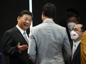 Prime Minister Justin Trudeau talks with Chinese President Xi Jinping after taking part in the closing session at the G20 Leaders Summit in Bali, Indonesia, Wednesday, Nov. 16, 2022.