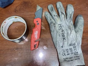Roll of duct tape, utility knife and dirty work glove.
