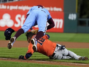 Philadelphia Phillies first baseman Rhys Hoskins scores Houston Astros Yuli Gurriel during a run during the seventh inning of Game 5 of the World Series of Baseball between the Houston Astros and Philadelphia Phillies, on Thursday, November 3, 2022, in Philadelphia.