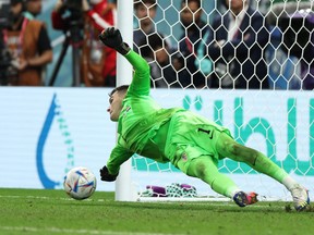 Croatia's Dominik Livakovic saves a penalty missed by Japan's Kaoru Mitoma.