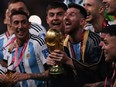 Argentina's captain and forward Lionel Messi lifts the FIFA World Cup Trophy during the trophy ceremony after Argentina won the Qatar 2022 World Cup final football match between Argentina and France at Lusail Stadium in Lusail, north of Doha on December 18, 2022.