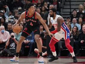 Raptors forward Scottie Barnes (left) controls the ball as Nets guard Kyrie Irving (right) tries to defend during first quarter NBA action at Scotiabank Arena in Toronto, Friday, Dec. 16, 2022.