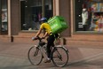 An Uber Eats food courier rides on bike for delivery. (Photo by Sean Gallup/Getty Images)