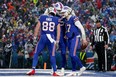 Dawson Knox #88, Spencer Brown #79 and Josh Allen #17 of the Buffalo Bills celebrates a touchdown from Allen in the fourth quarter of a game against the New York Jets at Highmark Stadium on December 11, 2022 in Orchard Park, New York. (Photo by Joshua Bessex/Getty Images)