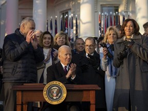 U.S. President Joe Biden applauds after signing the Respect for Marriage Act on the South Lawn of the White House in Washington, D.C., Tuesday, Dec. 13, 2022.