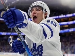 Mitch Marner celebrates his third-period goal against the Tampa Bay Lightning on Saturday night. Marner recorded at least a point in 19 consecutive games to set a new Maple Leafs record.