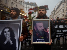Members of the Kurdish community attend a march organized by the Kurdish Democratic Council in France in tribute to the victims of Friday's deadly attack, in Paris, France, Monday, Dec. 26, 2022.
