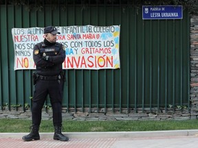 A police officer stands guard outside the Ukrainian embassy in Madrid after a bloody package arrived at the embassy, in the wake of several letter bombs arriving at targets connected to Spanish support of Ukraine, amidst Russia’s invasion of Ukraine, in Madrid, Spain, Friday, Dec. 2, 2022.