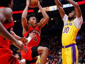 Raptors' Scottie Barnes drives to the net against Los Angeles Lakers' Damian Jones during the first half at Scotiabank Arena on Wednesday, Dec. 7, 2022 in Toronto.