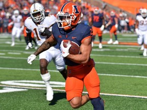 Illinois Fighting Illini running back Chase Brown scores a touchdown during the first half against the Minnesota Golden Gophers at Memorial Stadium.