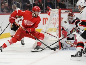 Senators netminder Cam Talbot guards the near post as Red Wings centre Michael Rasmussen tries to backhand the puck toward the net in the second period of Saturday's contest in Detroit.