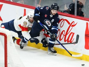 Winnipeg Jets defenceman Josh Morrissey (44) skates away from Florida Panthers forward Zac Dalpe (22) during the third period at Canada Life Centre in Winnipeg on Tuesday, Dec.6, 2022.
