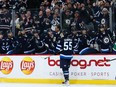 Winnipeg Jets forward Mark Scheifele (55) is congratulated by his teammates on his goal against the Vancouver Canucks during the second period at Canada Life Centre. Terrence Lee-USA TODAY Sports